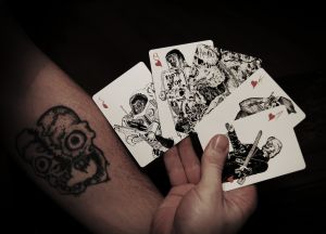 Cleaved skull tattoo with zombie cards
